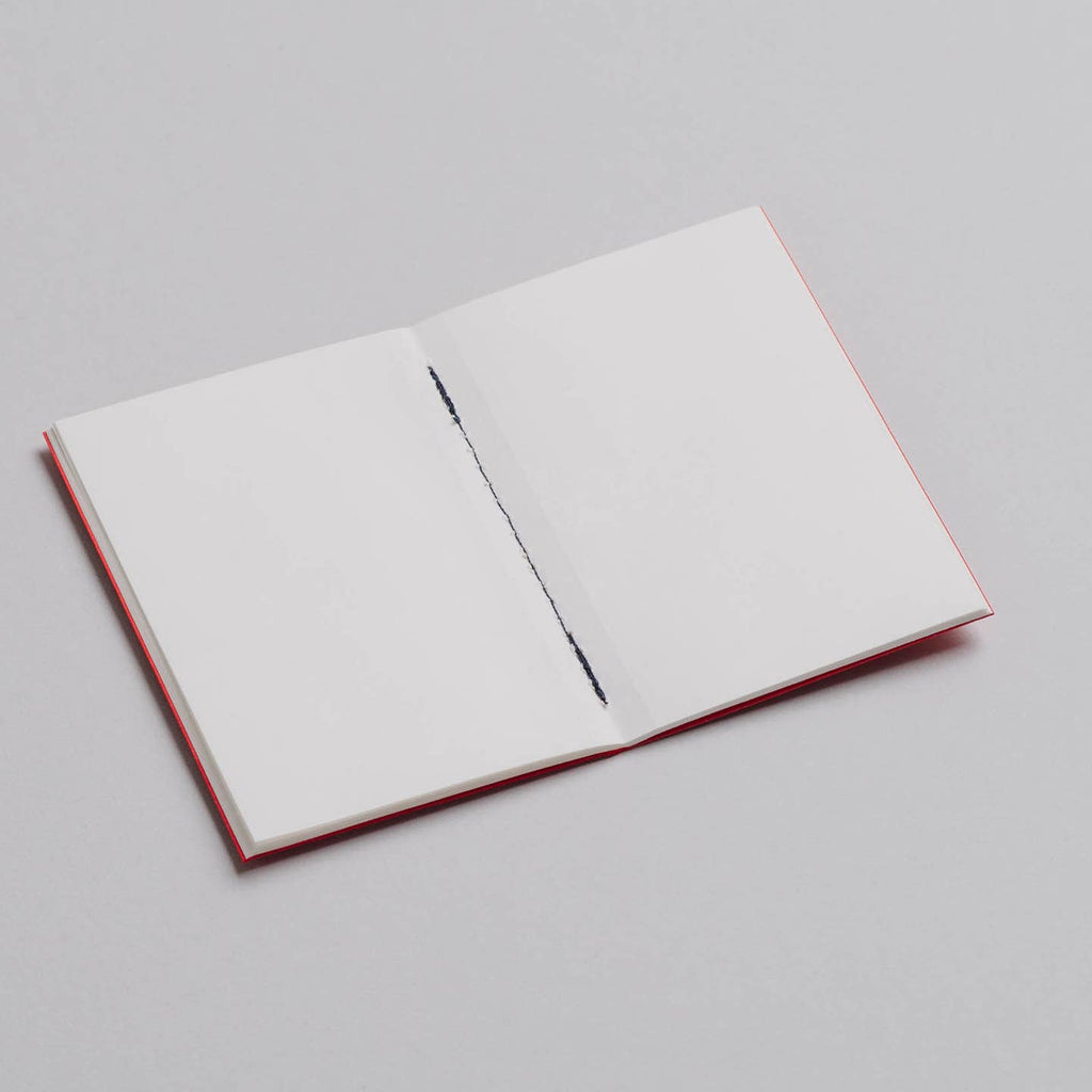 An Open pocket notebook with blank pages from the Pencil Me In stationery shop. 