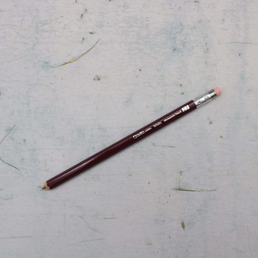 A Burgundy wooden mechanical pencil from the Pencil Me In stationery shop. 