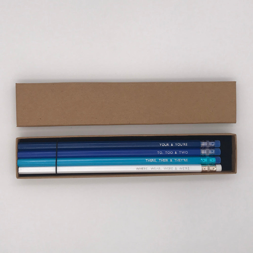 A foil printed set of grammar pencils in a gift box from the Pencil Me In stationery shop reading ‘YOUR & YOU'RE’.  A foil printed set of grammar pencils in a gift box from the Pencil Me In stationery shop reading ‘TO, TOO & TWO’.  A foil printed set of grammar pencils in a gift box from the Pencil Me In stationery shop reading ‘THERE, THEIR & THEY'RE’.  A foil printed set of grammar pencils in a gift box from the Pencil Me In stationery shop reading ‘WHERE, WEAR, WERE & WE'RE’.