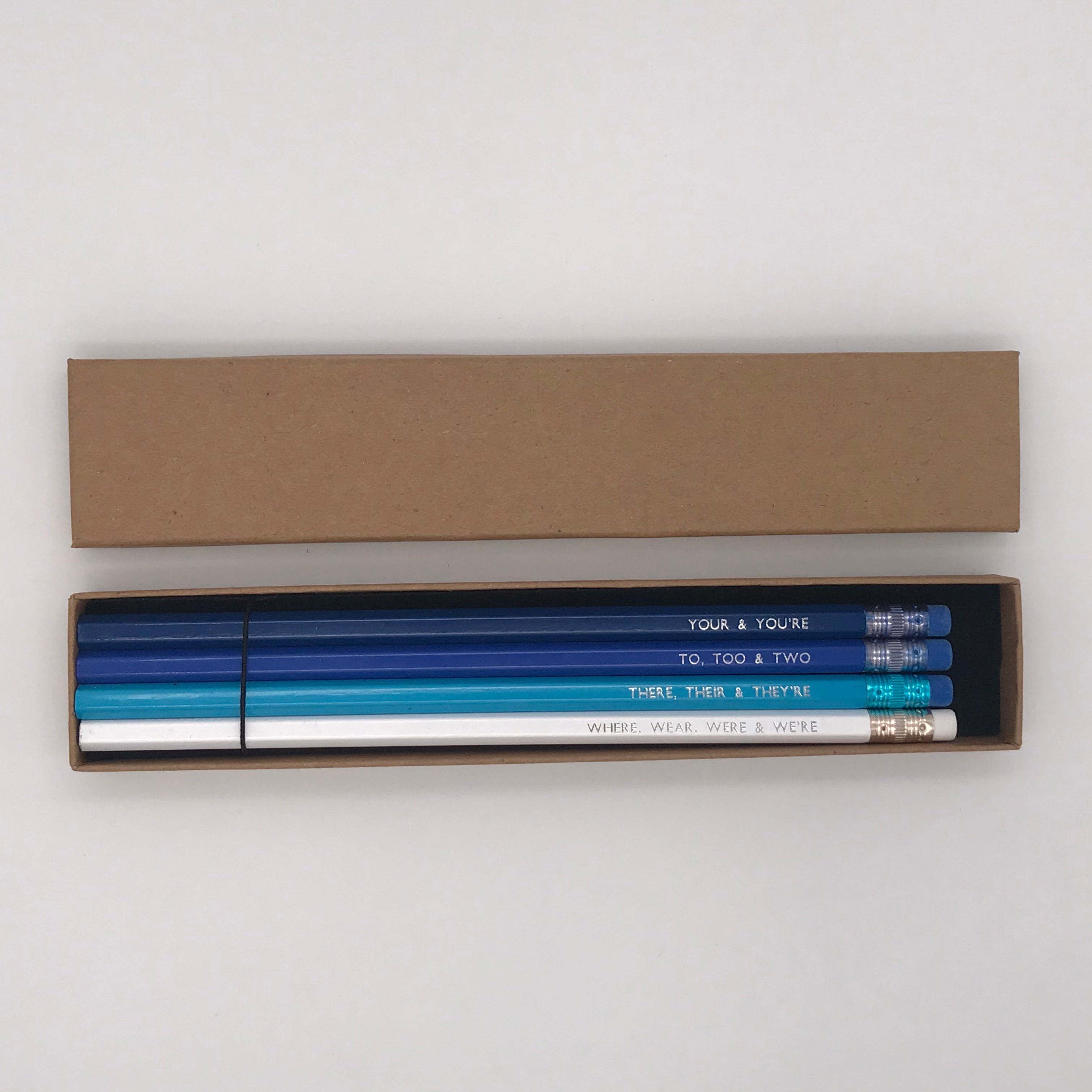 A foil printed set of grammar pencils in a gift box from the Pencil Me In stationery shop reading ‘YOUR & YOU'RE’.  A foil printed set of grammar pencils in a gift box from the Pencil Me In stationery shop reading ‘TO, TOO & TWO’.  A foil printed set of grammar pencils in a gift box from the Pencil Me In stationery shop reading ‘THERE, THEIR & THEY'RE’.  A foil printed set of grammar pencils in a gift box from the Pencil Me In stationery shop reading ‘WHERE, WEAR, WERE & WE'RE’.