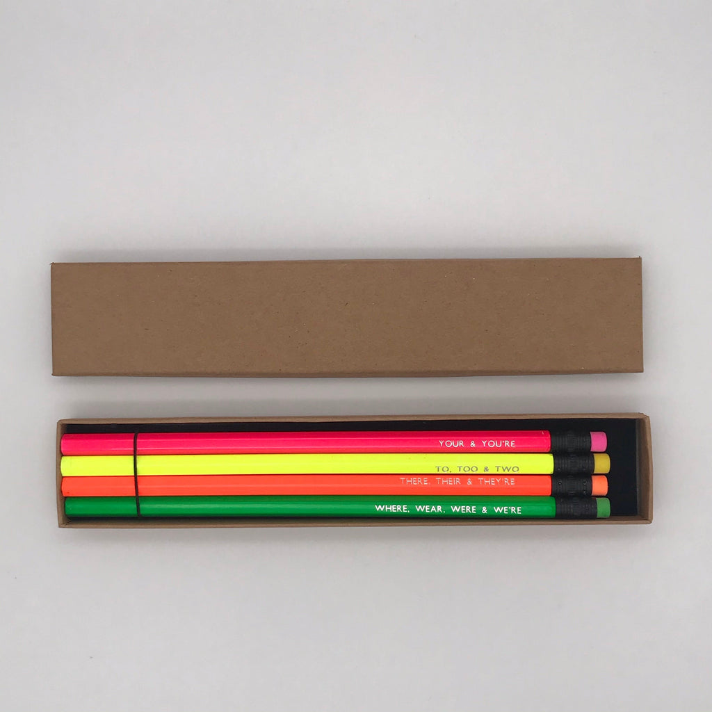 A foil printed set of grammar pencils in a gift box from the Pencil Me In stationery shop reading ‘YOUR & YOU'RE’.  A foil printed set of grammar pencils in a gift box from the Pencil Me In stationery shop reading ‘TO, TOO & TWO’.  A foil printed set of grammar pencils in a gift box from the Pencil Me In stationery shop reading ‘THERE, THEIR & THEY'RE’.  A foil printed set of grammar pencils in a gift box from the Pencil Me In stationery shop reading ‘WHERE, WEAR, WERE & WE'RE’.